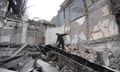Rescuers search rubble at an academic institute in Kyiv destroyed by Russian missiles launched from Crimea on 25 March.