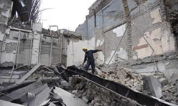 Rescuers search rubble at an academic institute in Kyiv destroyed by Russian missiles launched from Crimea on 25 March.