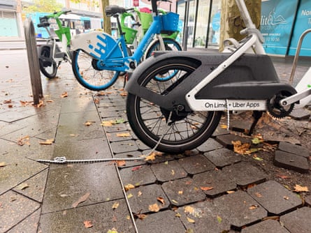 A Lime ebike with a broken chain on a Sydney street