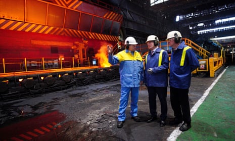 A Tata Steel employee talks to the Welsh first minister, Mark Drakeford (R) and the Labour leader, Keir Starmer (C) during a visit to the Port Talbot steelworks in south Wales.