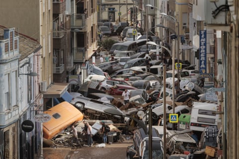 Cars piled up on a flood-stricken street in Alfafar, Valencia