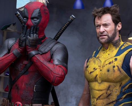 Ryan Reynolds and Hugh Jackman stand next to each other in a still from the film Deadpool & Wolverine