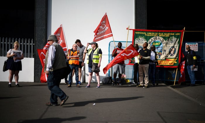 Rail workers strike outside the Waterloo Station.