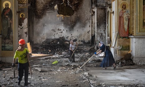 Ukrainians remove rubble at the Holy Transfiguration Cathedral in Odessa after the Russian missile strike