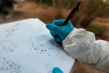 A forensics student documents evidence at the scene of a poaching incident at the academy.