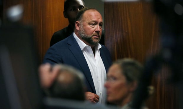 Alex Jones walks into the courtroom during the Austin trial on Thursday.