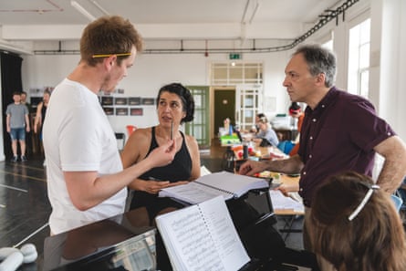Mathilde López, director, centre, with Jeremy Silver, conductor, right, during rehearsals for Carmen.