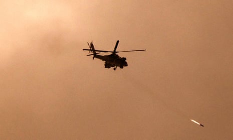 A picture taken from a position in southern Israel along the border with the Gaza Strip on December 29, 2023 shows an Israeli military helicopter firing a missile towards Gaza.