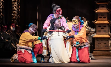 Masabane Cecilia Rangwanasha (Liù), kneeling center, with Hansung Yoo (Ping), Michael Gibson (Pong) and Aled Hall (Pang) at Turandot.