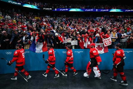 Canada players walk off the rink and celebrate with fans after the men’s ice hockey preliminary round match between Canada and France at the 2026 Winter Olympics