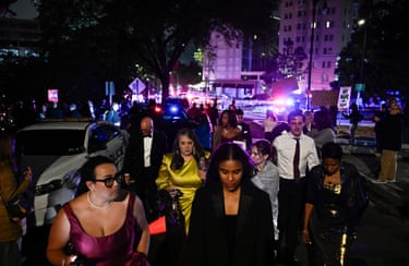 Attendees leave the Washington Hilton after shots were heard during the White House Correspondents’ Dinner.