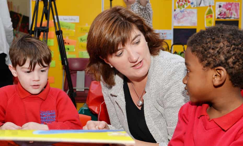 Education Secretary Nicky Morgan reads from a book to young children