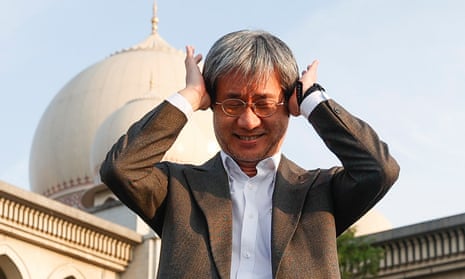 Malaysiakini editor-in-chief Steven Gan gestures outside the palace of justice in Putrajaya on Friday where his site was found guilty of contempt.