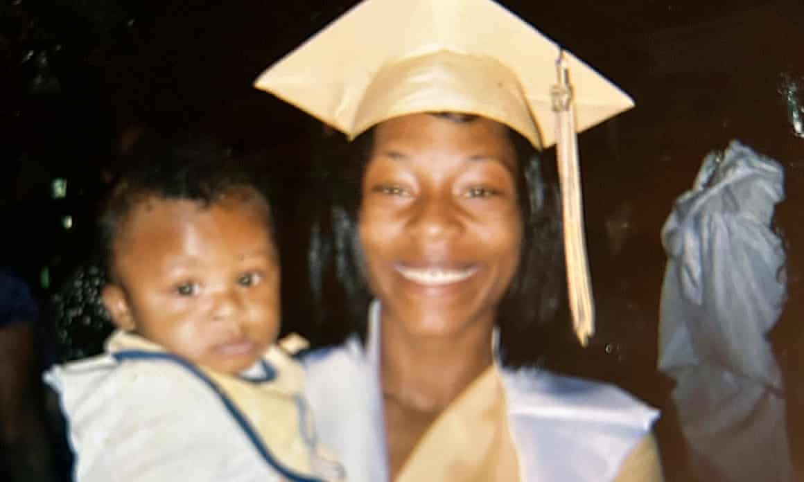 Sonya Massey, wearing a mortarboard hat, holding a baby