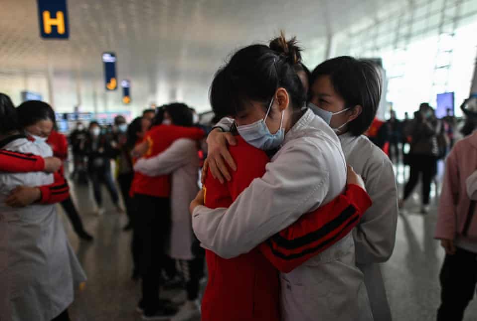 Medical staff from Jilin Province hug nurses from Wuhan after working together during a ceremony before leaving as Tianhe Airport is reopened in Wuhan in China’s central Hubei province on April 8.