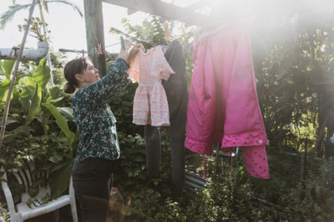 Jo Nemeth hangs out washing at the multigenerational home she shares with her friend, her daughter and others in Lismore in northern NSW.