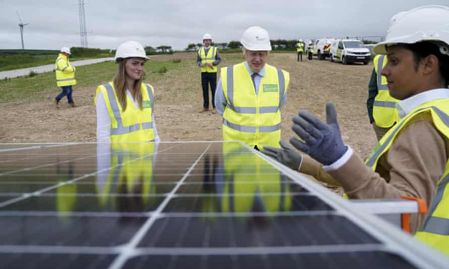 Boris Johnson views a solar panel at ScottishPower's Carland Cross wind farm in Newquay, Cornwall.