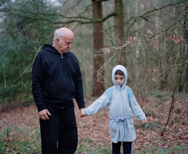 Julian and Jonathan, December 2007For me, this is a very important photograph in the series, as it was the first time I photographed my father and half-brother, Jonathan (who was about to turn seven), with my medium-format Mamiya— the camera I have continued to use ever since. This was also the moment I realized I wanted to keep photographing them.I took this photo outside a small holiday home where we were staying for the weekend. I love Julian and Jonathan’s hands in this image—how Jonathan’s hand is wrapped around my father’s thumb, his other hand clenched into a fist while he bites the hood of his light blue bathrobe. Jonathan’s stiff posture, next to Julian’s somewhat resigned pose, continues to fascinate me.
