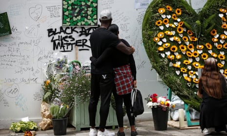 People attend a commemoration in June 2020 to mark the third anniversary of the Grenfell Tower fire in London