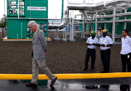 Former US president Bill Clinton visiting a new power plant in Caracol, Haiti, in 2012