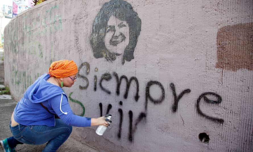A woman spray-paints the phrase ‘Always Alive’ below a stencilled image of Berta Cáceres during the commemoration of international women’s day in Tegucigalpa on 8 March.