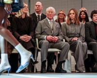 The king sits in the front row, next to designer Stella McCartney, as models pass by