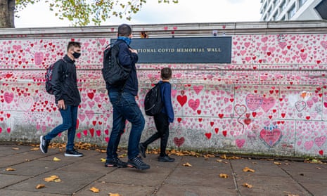 People walking past the Covid national memorial wall in London, UK.