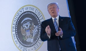 Donald Trump at the Turning Point event, featuring a two-headed eagle with golfing gear.