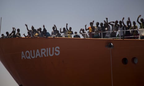 Migrants wave from the Aquarius during an earlier rescue operation.