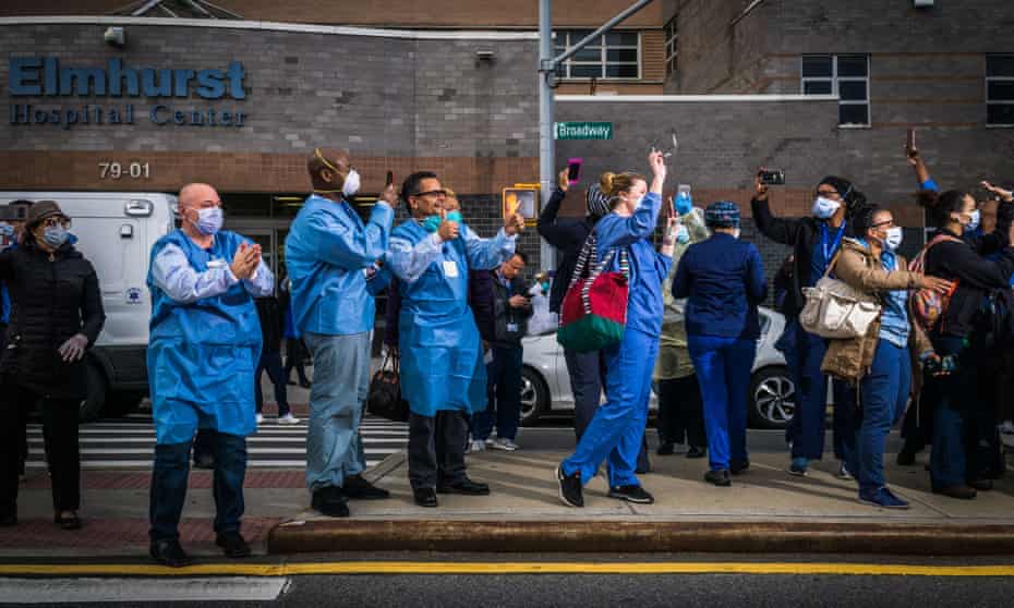 Workers show their appreciation for healthcare professionals outside Elmhurst hospital in Queens. De Blasio said: ‘Next week in New York City is going to be very tough.’