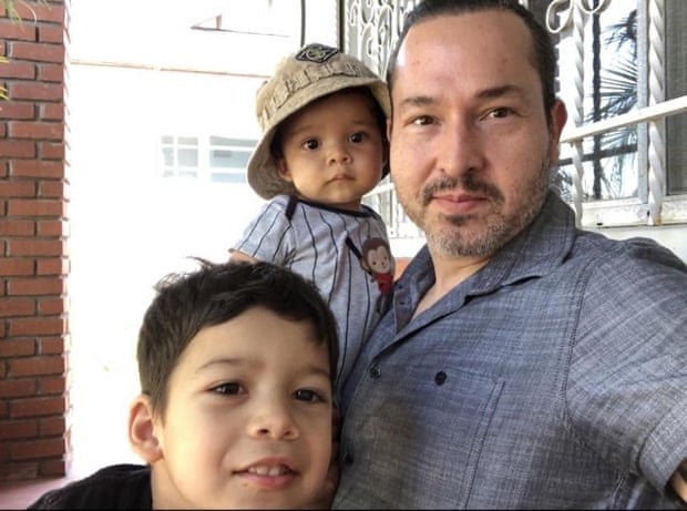 A man with two young children in a selfie