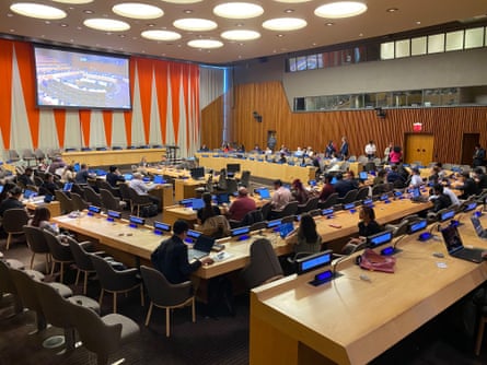 people sit at tables in an auditorium
