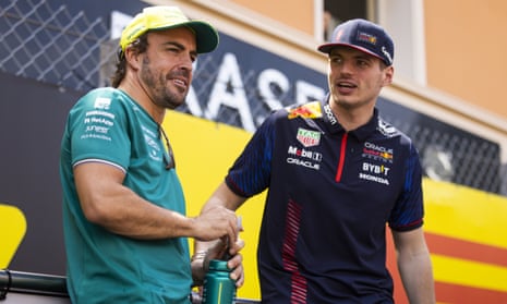 Max Verstappen (right) stops for a chat with Fernando Alonso