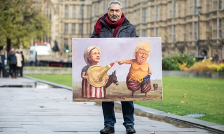 Political artist Kaya Mar shows a US election-themed artwork at College Green, Westminster.