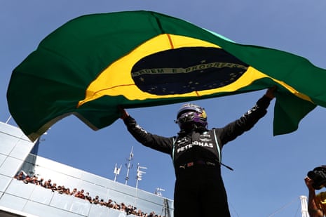 Lewis Hamilton celebrates with the Brazilian flag.