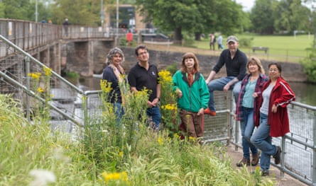 Volunteers standing by the River Tone.