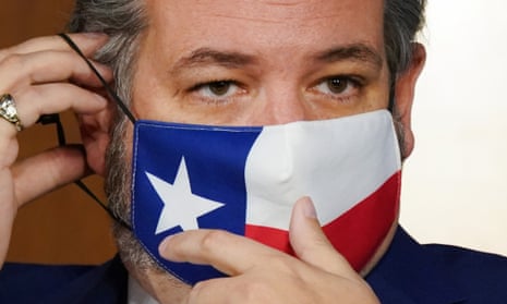 Ted Cruz adjusts his mask.