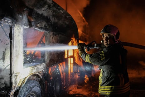 In this photo provided by the Ukrainian Emergency Situations Ministry, a firefighter tries to put out fire caused by fragments of a rocket.