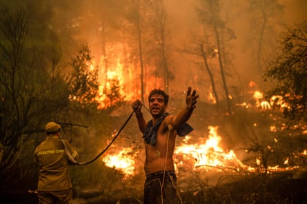 People on the island of Evia fight wildfires in August 2021, during Greece’s worst heatwave in decades