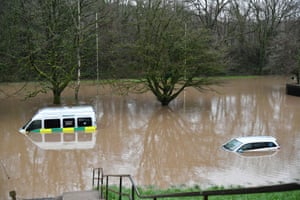 Submerged vehicles after flooding in Nantgarw, Wales.