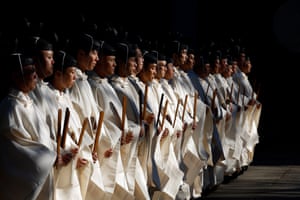 Shinto priests line up in their white gowns