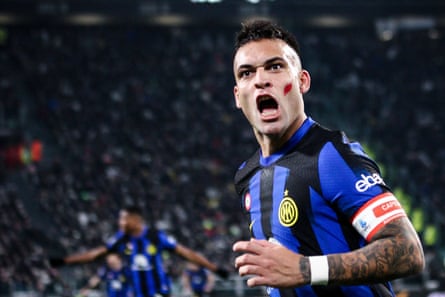 Lautaro Martínez celebrates after scoring the equaliser for Inter. Serie A players wore a red mark on their faces this weekend in a message against domestic violence.