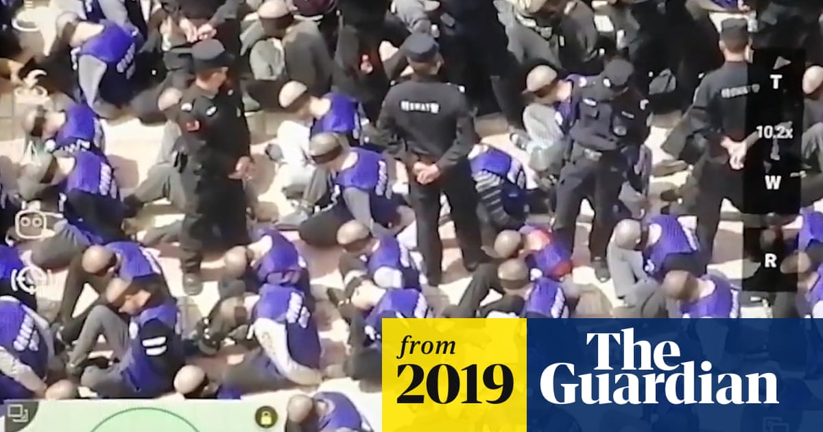 Footage shows hundreds of blindfolded and shackled prisoners in China – video | World news | The Guardian