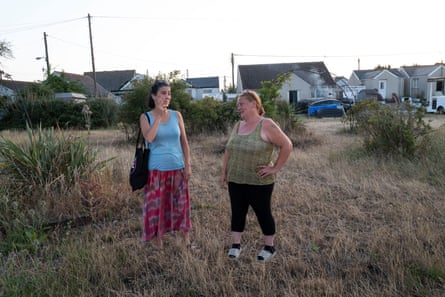 Architect Hanna Loftus (left) with Danell Dreelan, a matriarchal figure and well-known resident in Jaywick, stand in a grassy area in front of some houses