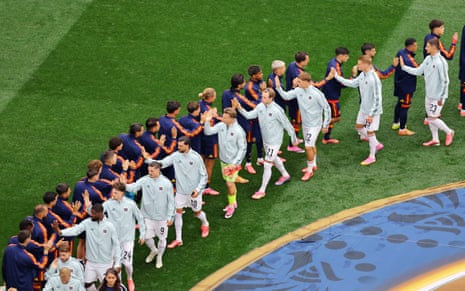 Spain and Austria players shake hands before the match.