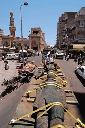 Lying in state ... the statue of a Ptolemaic pharaoh travels through the streets of Alexandria.
