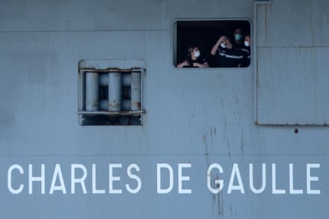 French sailors wearing face masks aboard the aircraft carrier Charles de Gaulle as it arrived in Toulon earlier this week