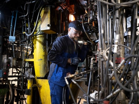 A worker operates machinery.