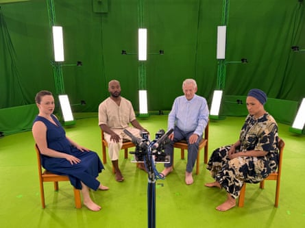 four people sitting in chairs in a green room