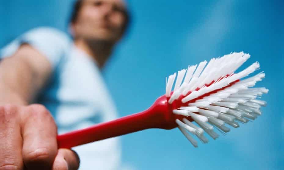 a man holding a scrubbing brush